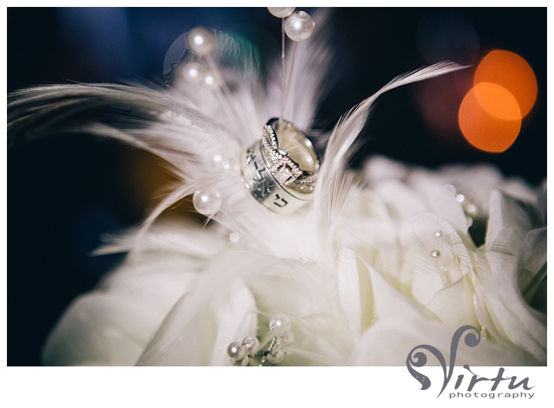 wedding rings   feathers in bouquet